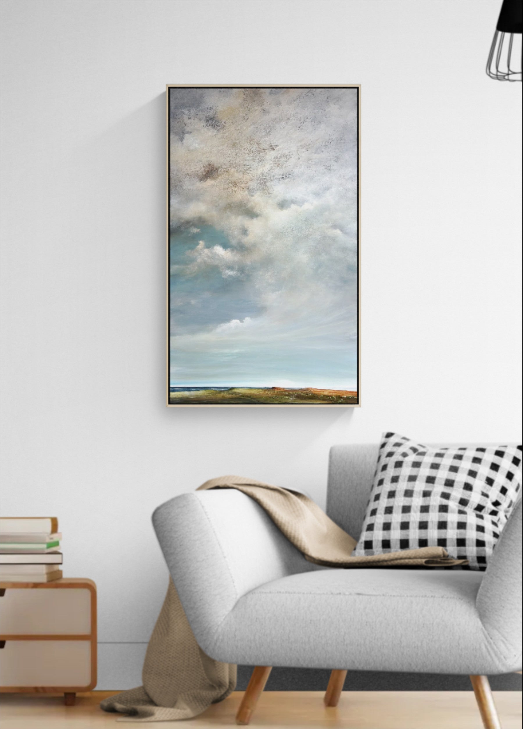 Large abstract blue and white cloudscape painting, Beneath A Silver Sky, creating a calm focal point in a modern interior.