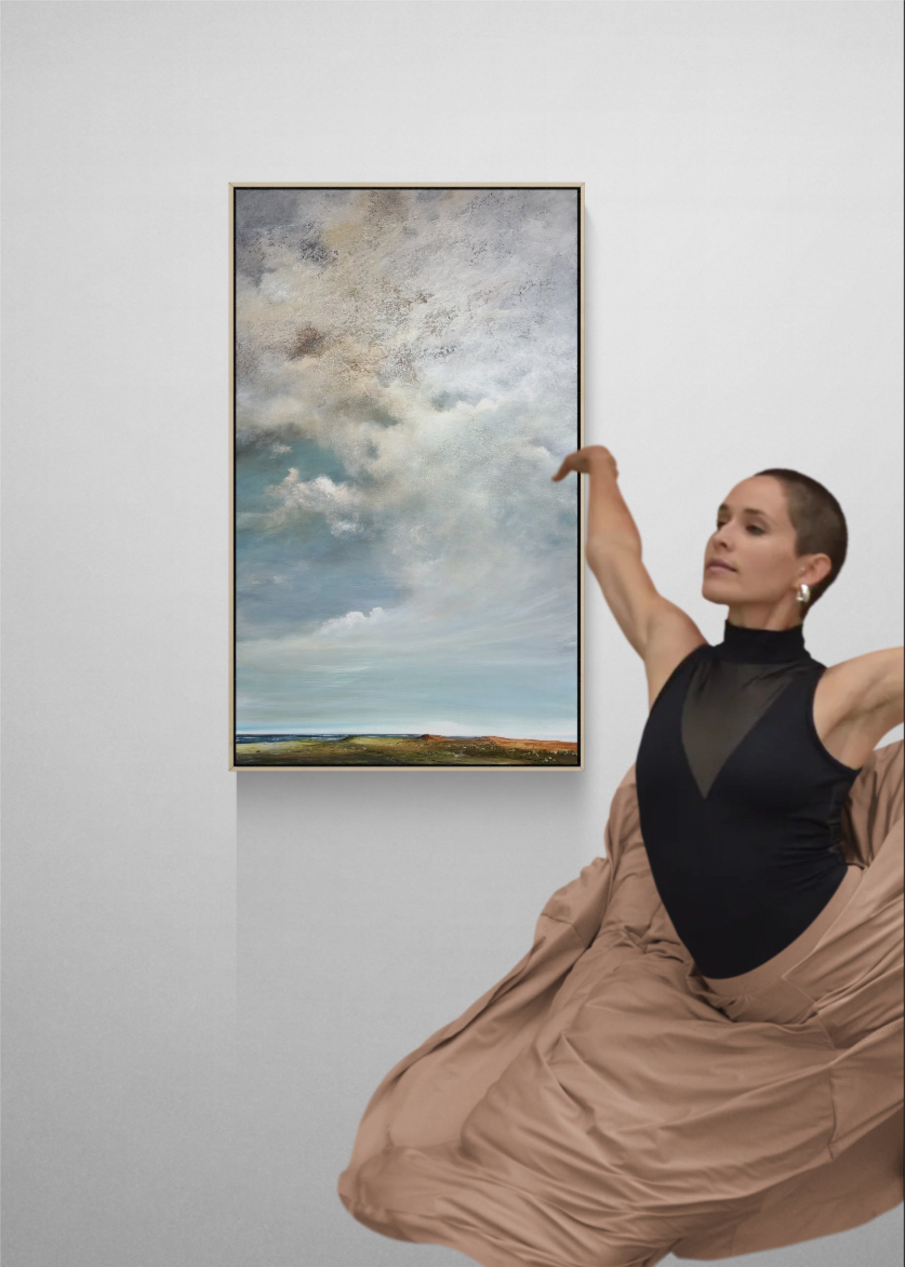 Large abstract blue and white cloudscape painting, Beneath A Silver Sky, creating a calm focal point in a modern interior.