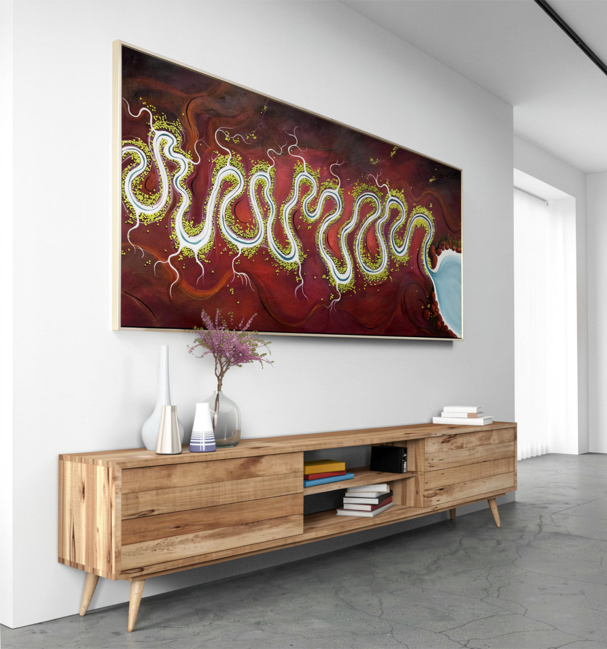 A large horizontal original landscape featuring an abstract red and burgundy design with glowing wavy green and yellow lines, displayed in a light wood frame on a white wall above a wooden media console.